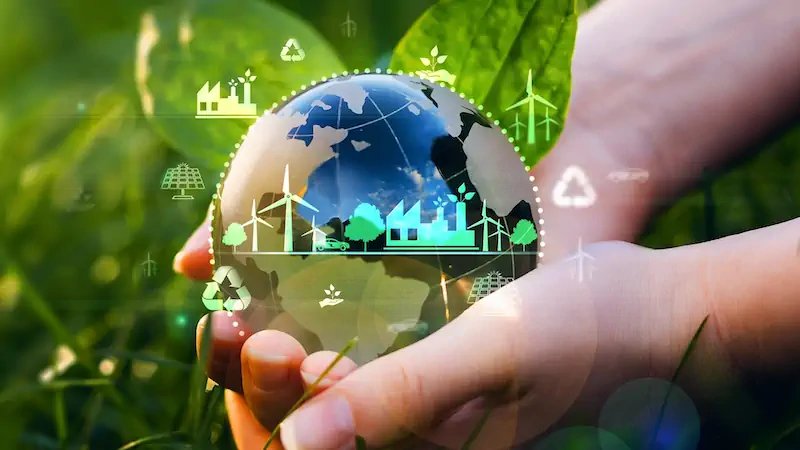 Hands holding a globe with eco and clean energy icons, symbolizing sustainability.