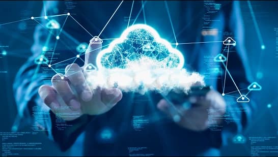 A person using a stylus on a laptop with a holographic data flow diagram displayed on the screen. The image represents enterprise data processing, digital workflows, and data integration within an enterprise data platform.
