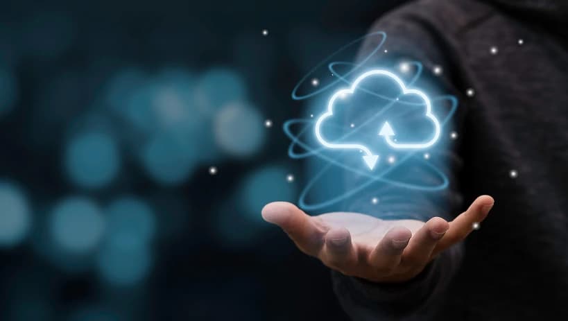 Cloud computing icon hovering above a hand, representing data upload and download